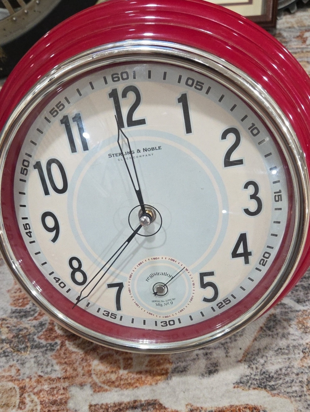 This is a retro-style decorative wall clock made by Sterling & Noble.